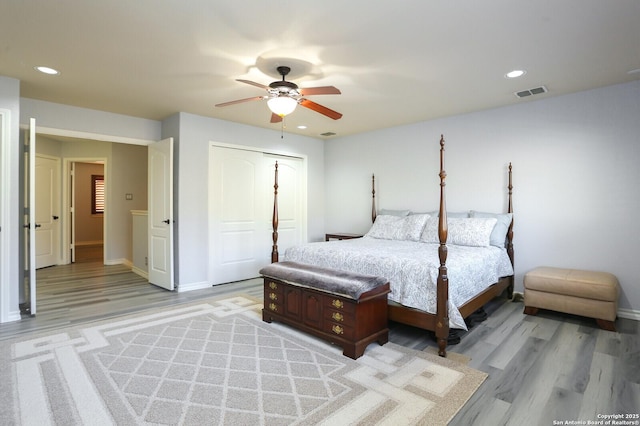 bedroom with a closet, ceiling fan, and light hardwood / wood-style floors