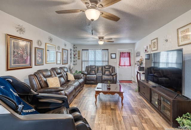 living room featuring a textured ceiling, ceiling fan, and hardwood / wood-style floors