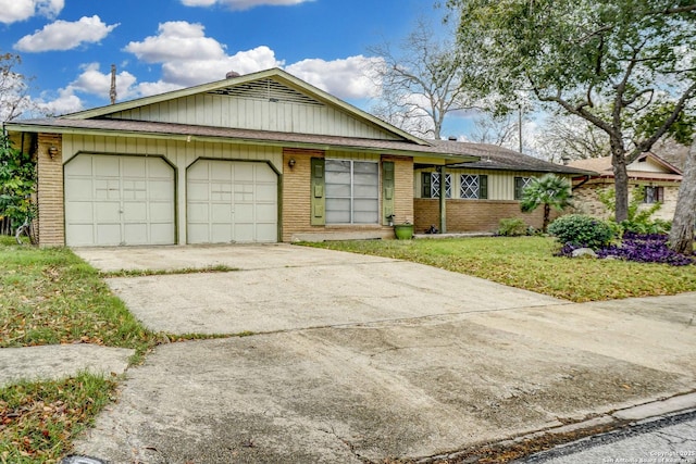 view of front of property with a front yard and a garage