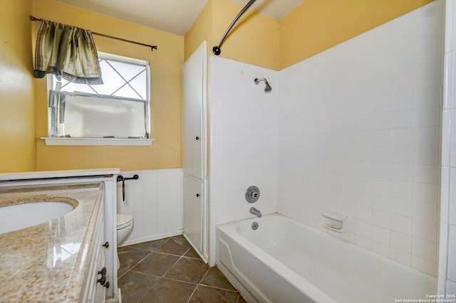 full bathroom featuring toilet, vanity, tile patterned flooring, and tiled shower / bath