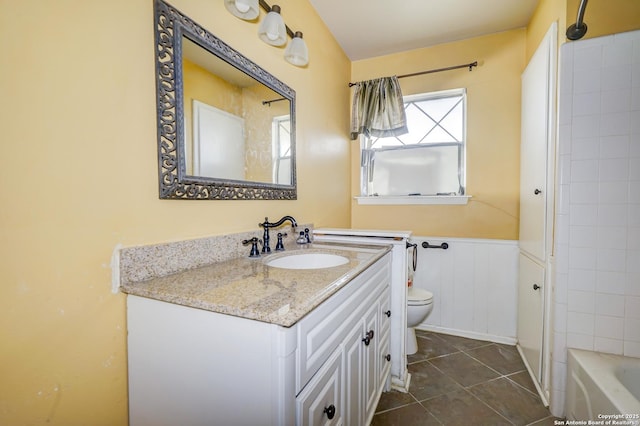 full bathroom featuring toilet, vanity, tiled shower / bath combo, and tile patterned flooring