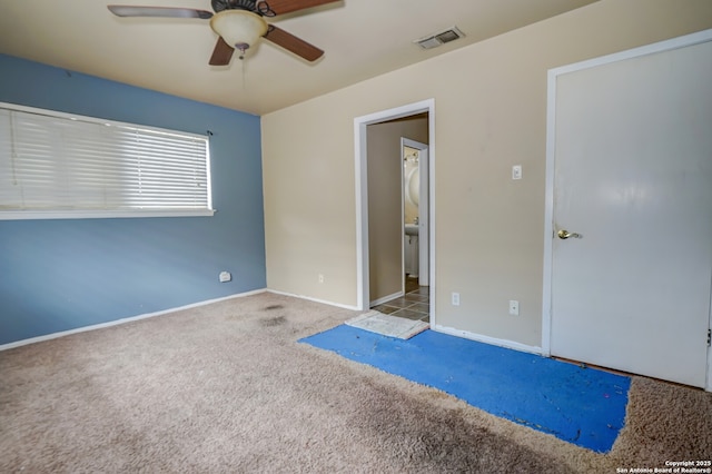 spare room with ceiling fan and light carpet