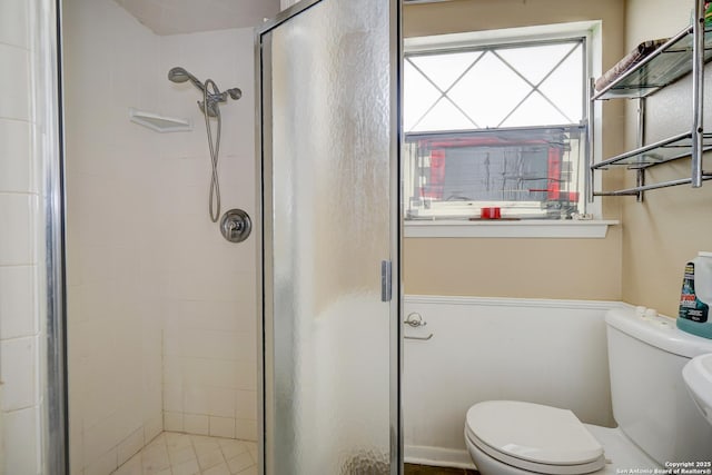 bathroom featuring toilet and walk in shower