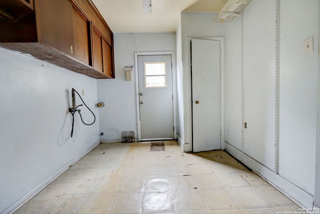 washroom with washer hookup and cabinets