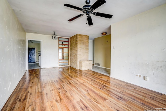 unfurnished living room with ceiling fan and hardwood / wood-style floors