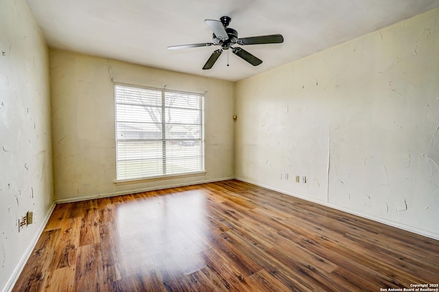 empty room featuring ceiling fan and hardwood / wood-style flooring