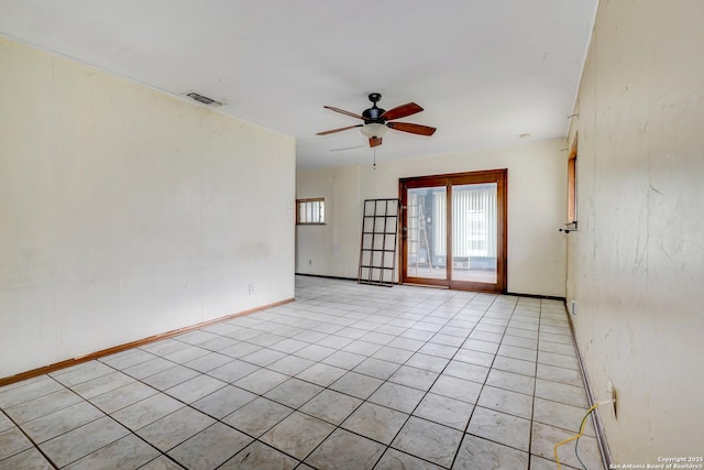 empty room with ceiling fan and light tile patterned floors