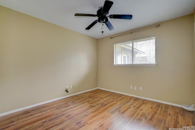 spare room with ceiling fan and light wood-type flooring