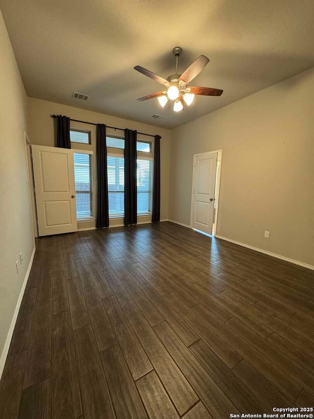 spare room with ceiling fan and dark hardwood / wood-style floors