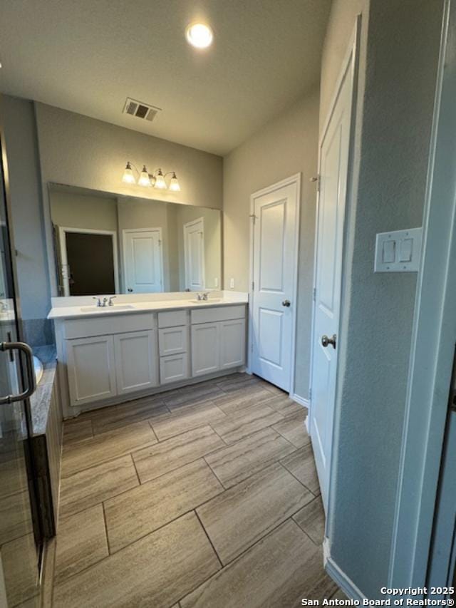 bathroom featuring plus walk in shower and vanity