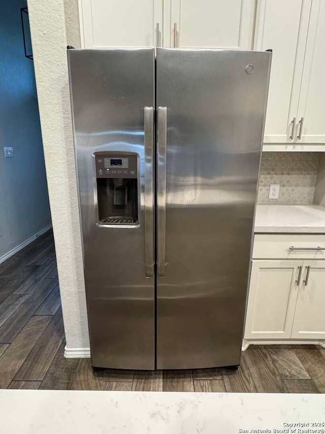 kitchen featuring white cabinetry, backsplash, and stainless steel fridge with ice dispenser