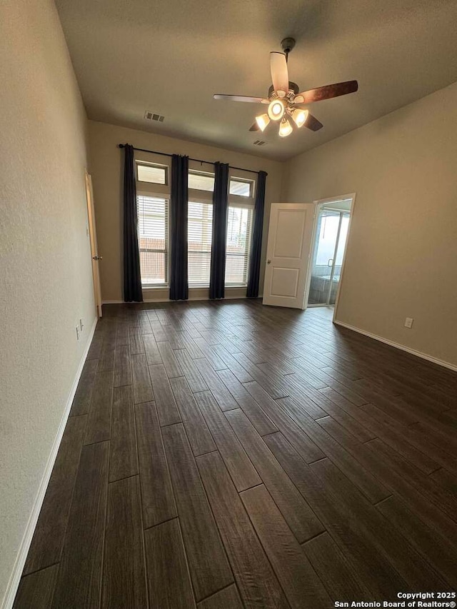 spare room featuring dark hardwood / wood-style flooring and ceiling fan