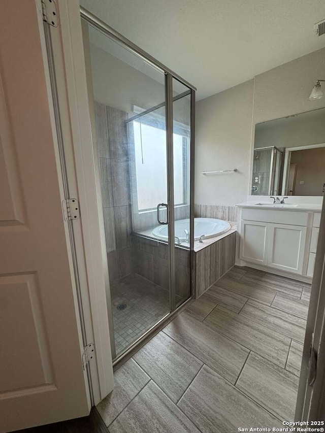 bathroom with plus walk in shower and vanity