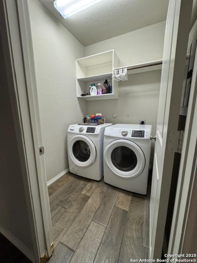 laundry area featuring independent washer and dryer, dark hardwood / wood-style flooring, and a textured ceiling