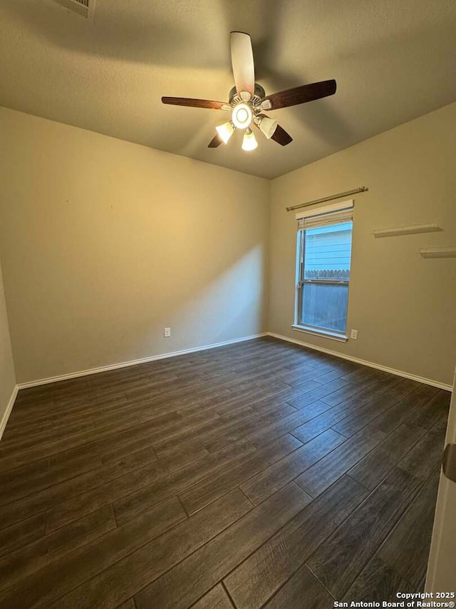 spare room featuring ceiling fan and dark hardwood / wood-style floors