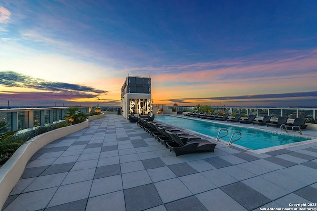 view of pool at dusk