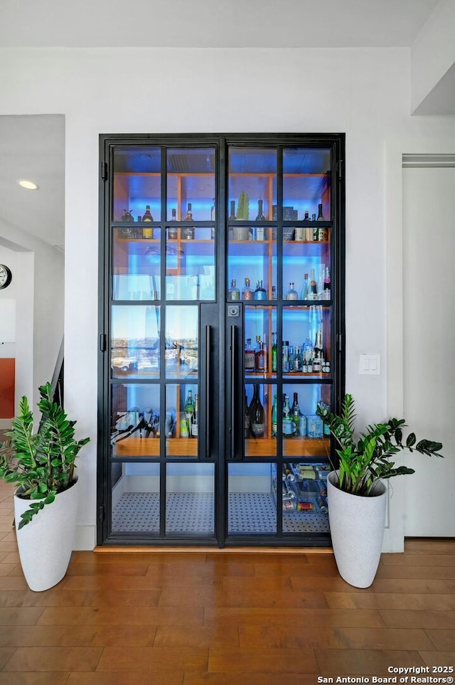 interior space with hardwood / wood-style flooring and indoor bar