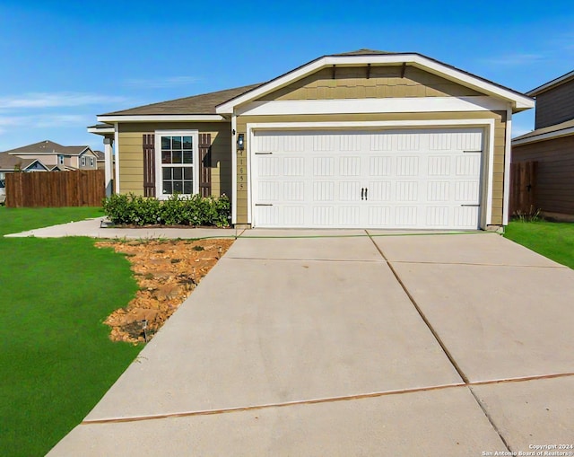 ranch-style house with a garage and a front lawn