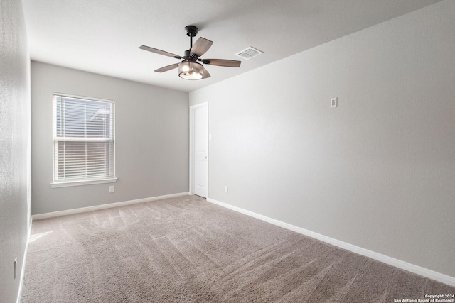 unfurnished room with ceiling fan and light colored carpet