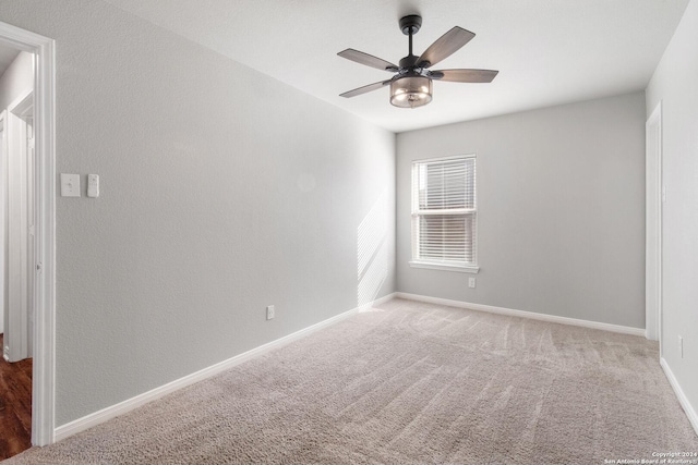 empty room with ceiling fan and carpet flooring