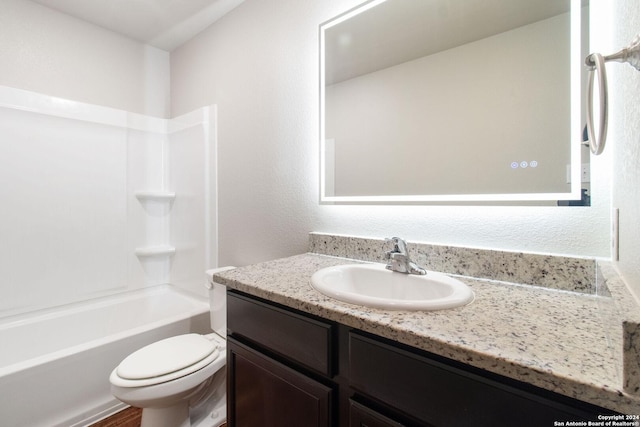 full bathroom featuring tub / shower combination, toilet, and vanity