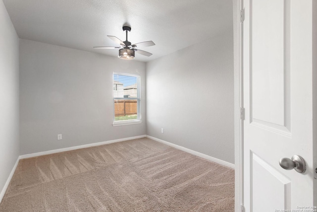 empty room featuring a textured ceiling and carpet flooring