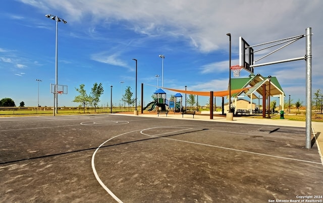 view of basketball court with a playground