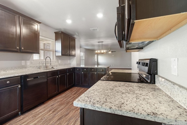 kitchen featuring hardwood / wood-style floors, black appliances, sink, hanging light fixtures, and dark brown cabinets