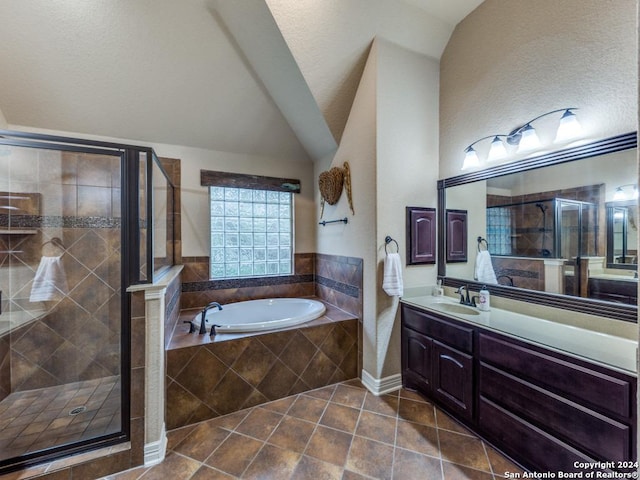 bathroom with tile patterned flooring, vanity, vaulted ceiling, and plus walk in shower