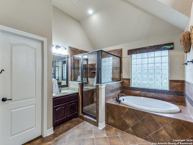 bathroom featuring vanity, vaulted ceiling, tile patterned floors, and independent shower and bath