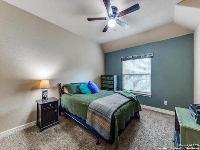 carpeted bedroom featuring ceiling fan and vaulted ceiling