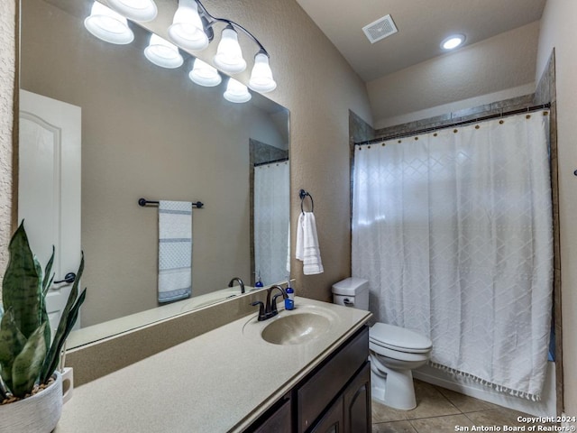 bathroom with toilet, vaulted ceiling, tile patterned floors, and vanity