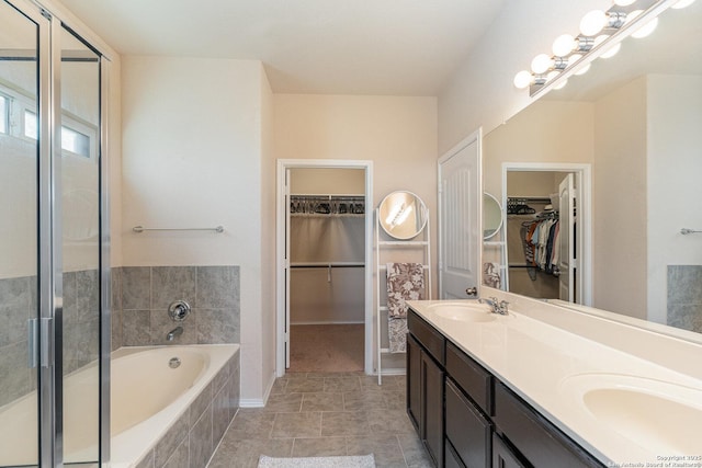 bathroom with independent shower and bath, tile patterned flooring, and vanity