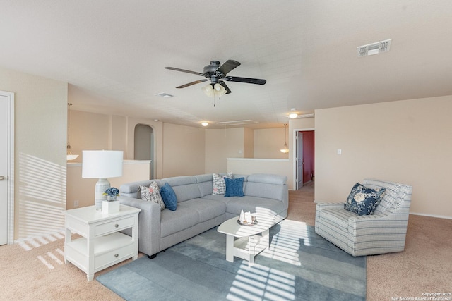 living room featuring carpet floors and ceiling fan