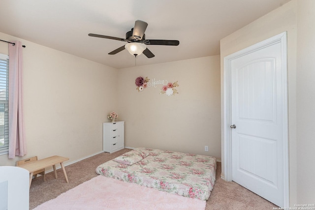 bedroom with ceiling fan and light colored carpet