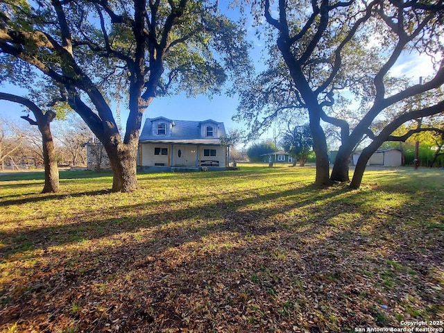 view of yard featuring an outbuilding and covered porch