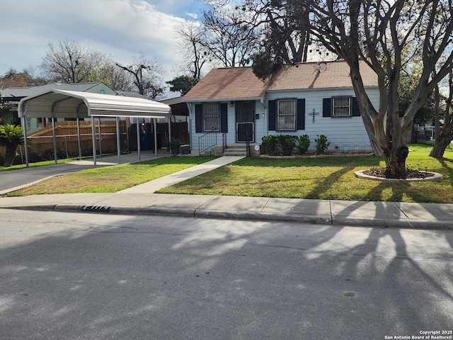 view of front facade with a carport and a front yard