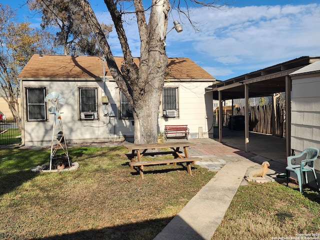 rear view of property featuring a yard, a patio, and cooling unit