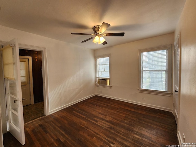 unfurnished room with ceiling fan and dark wood-type flooring