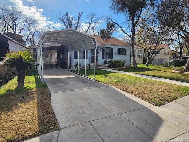 view of front of house with a front lawn and a carport