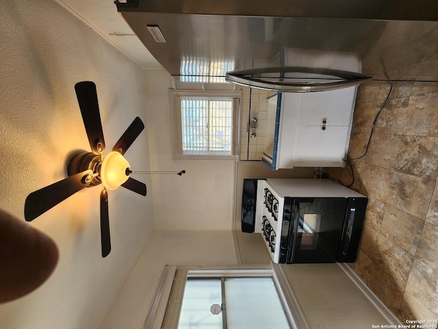 interior space featuring ceiling fan