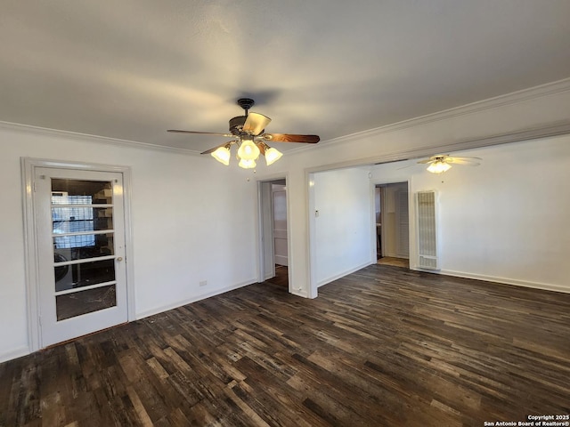 spare room featuring dark wood-type flooring and ornamental molding