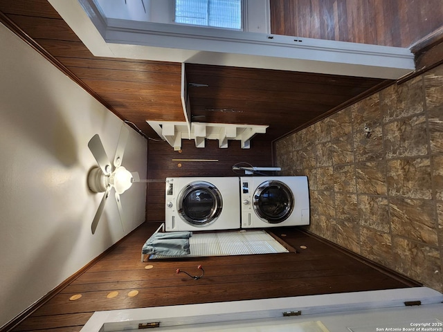 clothes washing area featuring washing machine and dryer, wooden ceiling, and hardwood / wood-style floors