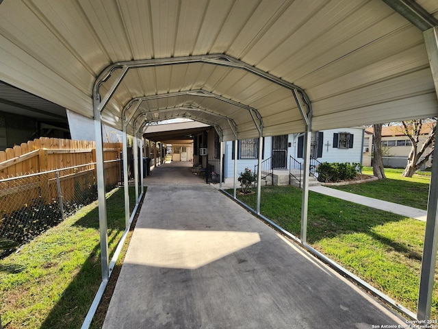 view of parking with a lawn and a carport