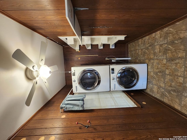 clothes washing area with wooden ceiling, dark hardwood / wood-style floors, independent washer and dryer, and wooden walls