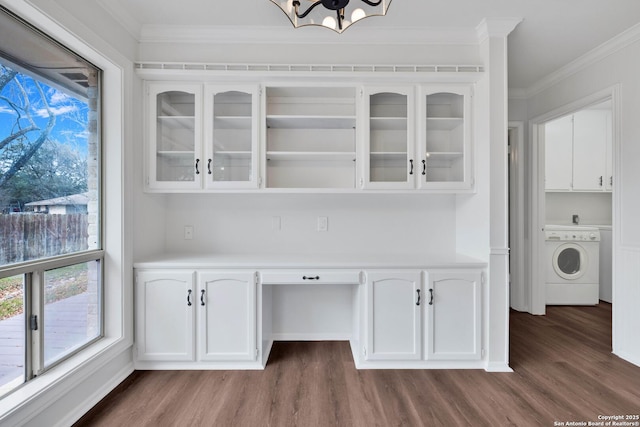 interior space featuring washer / dryer, an inviting chandelier, dark hardwood / wood-style flooring, and crown molding