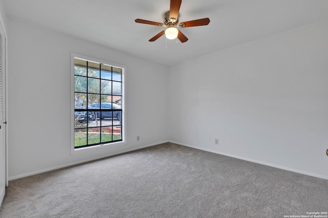 carpeted empty room featuring ceiling fan