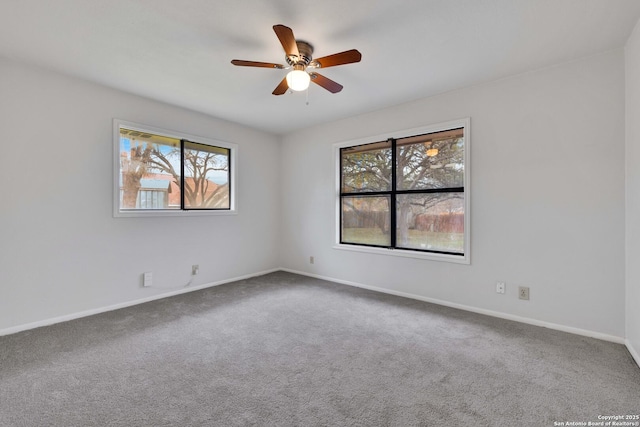 carpeted spare room featuring ceiling fan