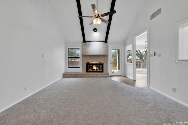 unfurnished living room featuring ceiling fan, carpet, a fireplace, and high vaulted ceiling