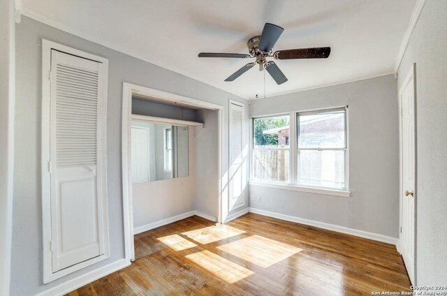 unfurnished bedroom with ceiling fan, light hardwood / wood-style floors, and ornamental molding